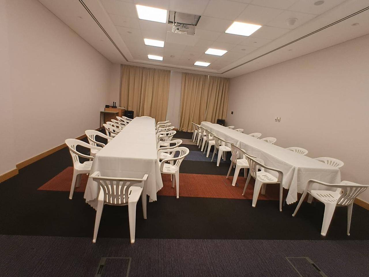Plastic chair package with white plastic chairs around event tables
